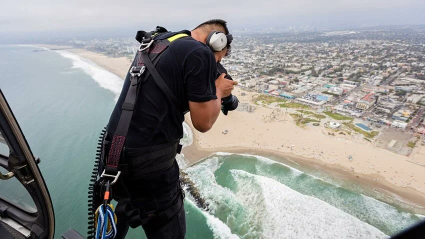 BlueForest camera operator shooting aerials from a helicopter over the coast